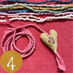 beaded plant-dyed wool felt hearts on silk cordage