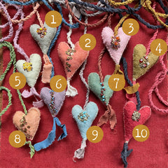 beaded plant-dyed wool felt hearts on silk cordage