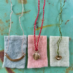 choker necklace in a plant-dyed matchbox: basin, leaf & pebble