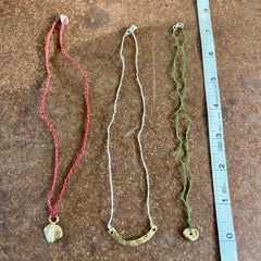 choker necklace in a plant-dyed matchbox: basin, leaf & pebble