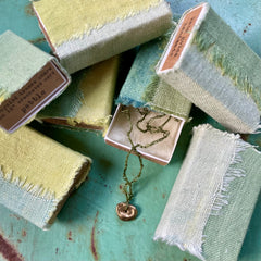 choker necklace in a plant-dyed matchbox: basin, leaf & pebble