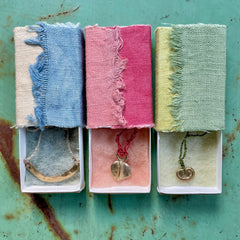 choker necklace in a plant-dyed matchbox: basin, leaf & pebble